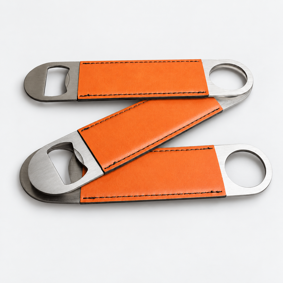 Orange leatherette bottle openers before custom UV printing, light gray background