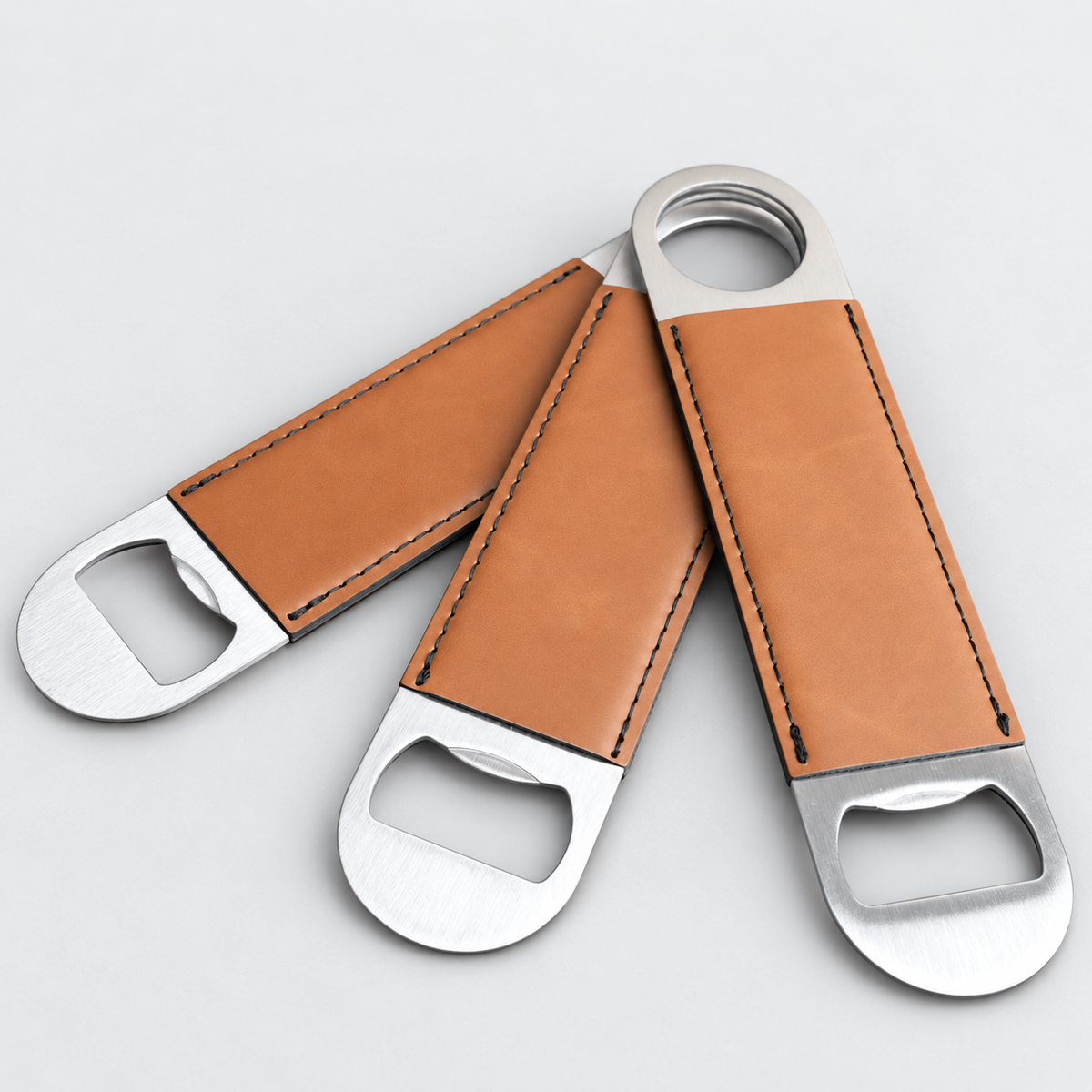 Rawhide leatherette bottle openers before custom UV printing, light gray background
